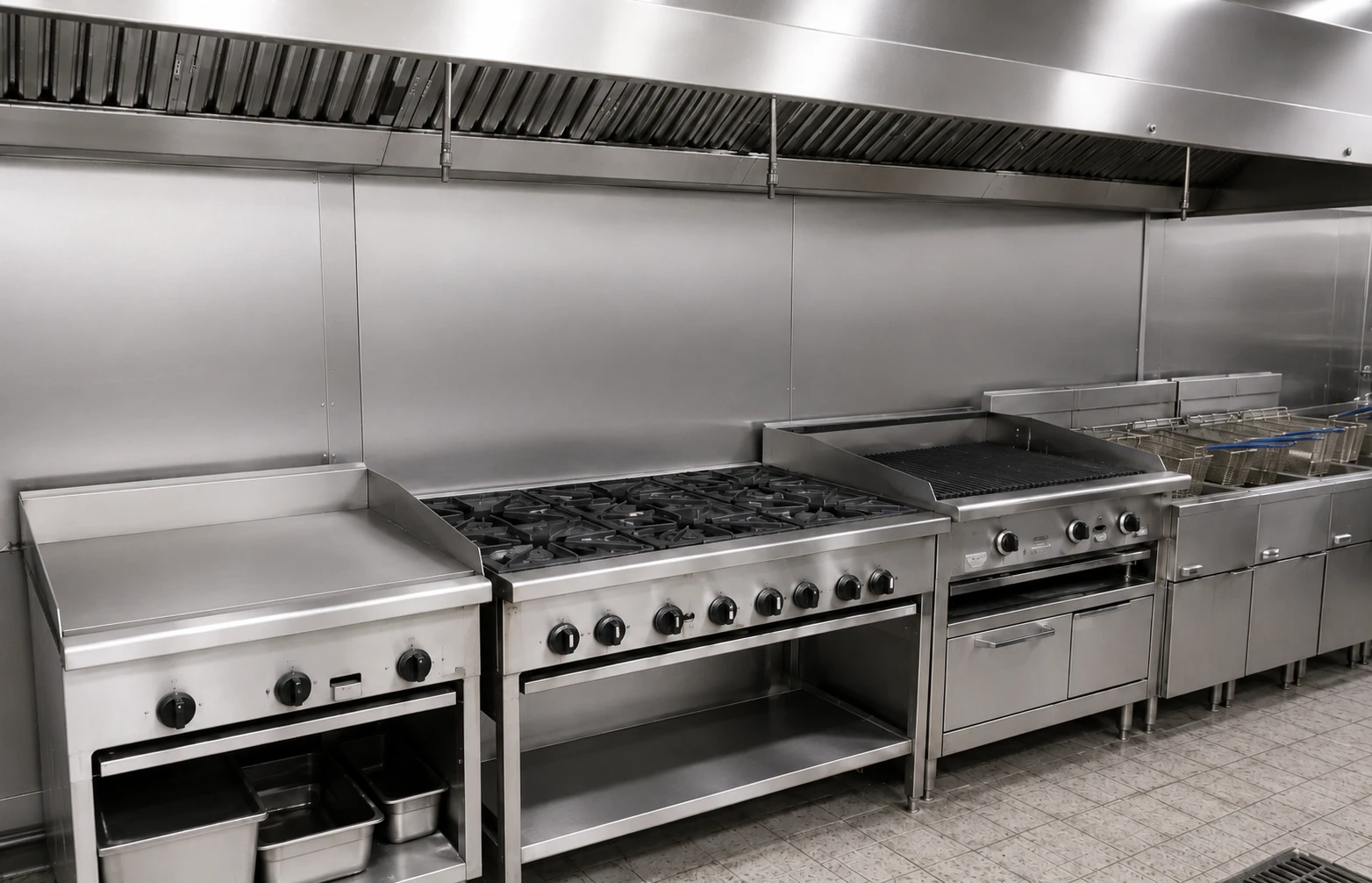 The same cooking line stripped back to clean stainless after a scheduled deep clean.